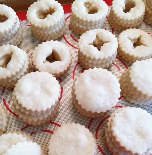 Linzer cookies baked on baking sheet ready for filling