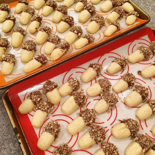 Cookie sheets filled with dipped Orange Chocolate Cookie logs