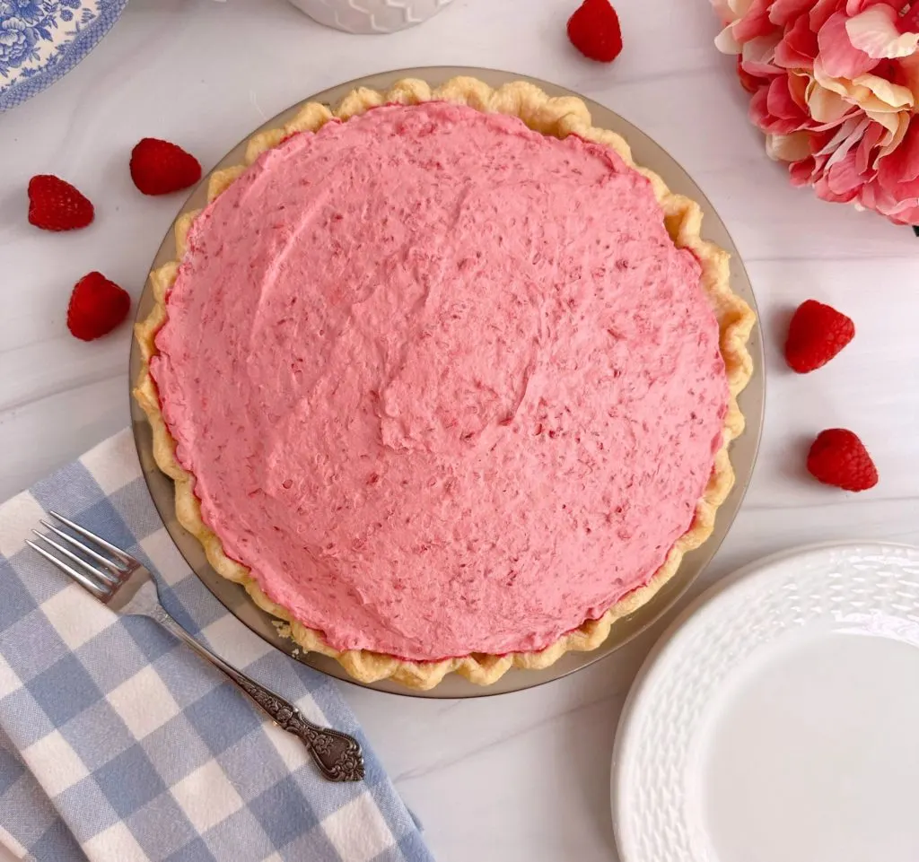 Raspberry Cream Pie overhead shot with raspberry filling on top of pie.