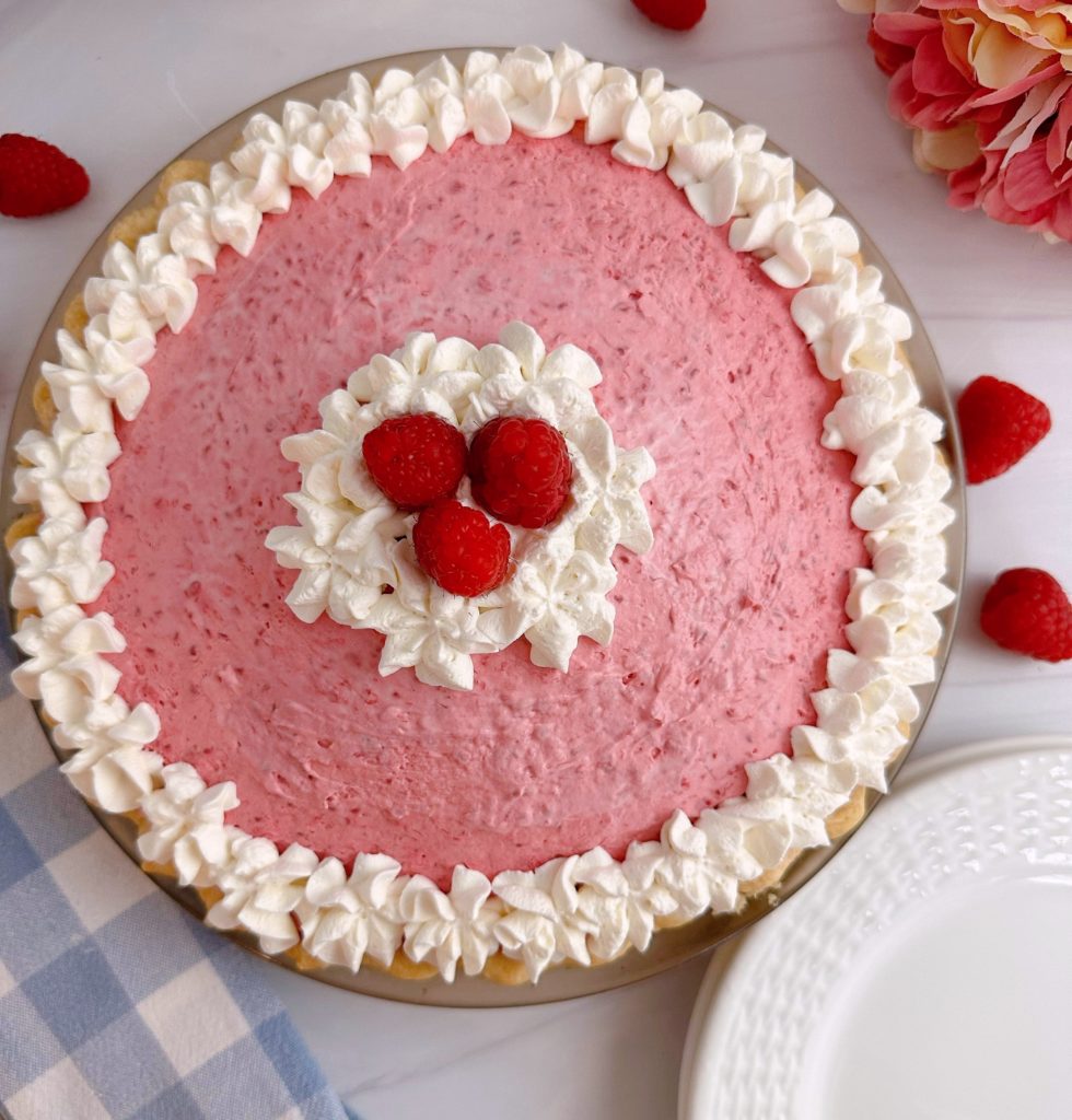 Raspberry Cream Pie with garnish and fresh raspberries.