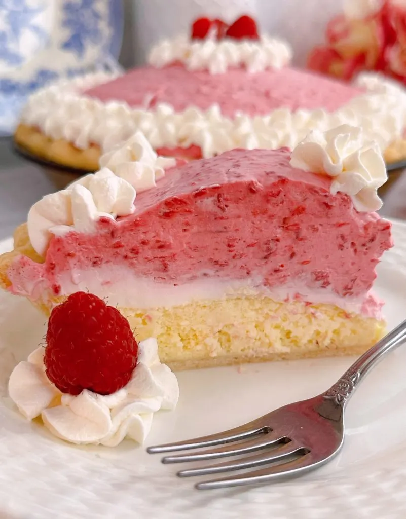 Slice of Raspberry Cream Pie on a plate with a fork.