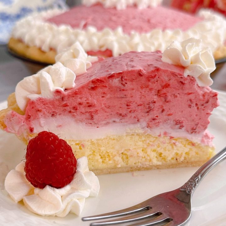 Slice of Raspberry Cream Pie on a plate with a fork.