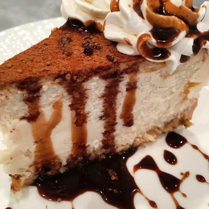 Tiramisu Cheesecake with Kahlua Chocolate Syrup on a plate