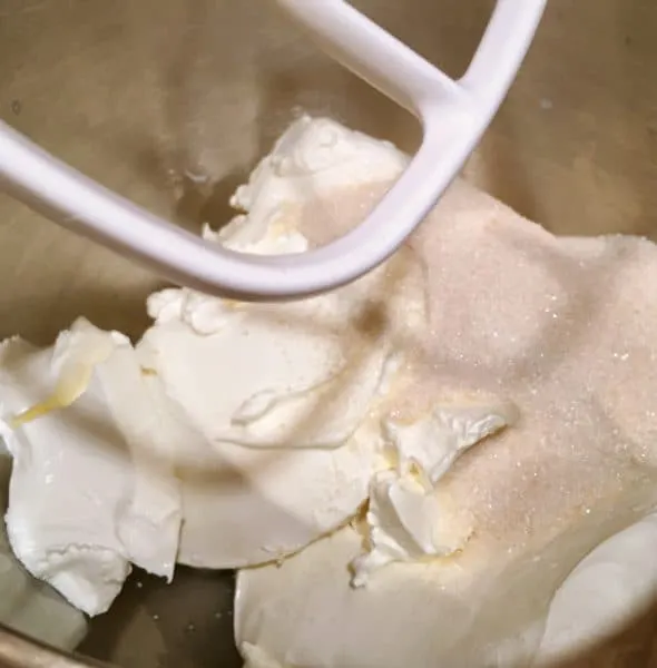 cream cheese and sugar in mixing bowl ready to beat