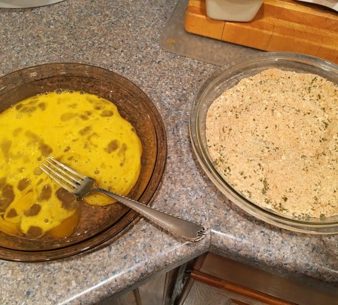 Dish filled with eggs and a dish filled with bread crumbs