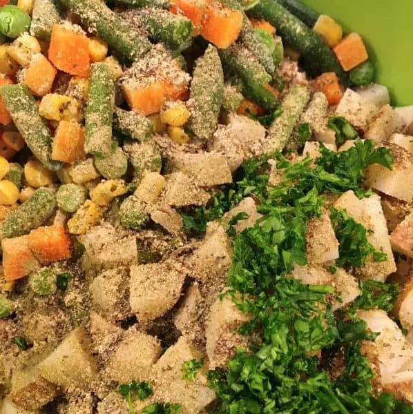 Spices and herbs added to chicken and vegetables for pot pie