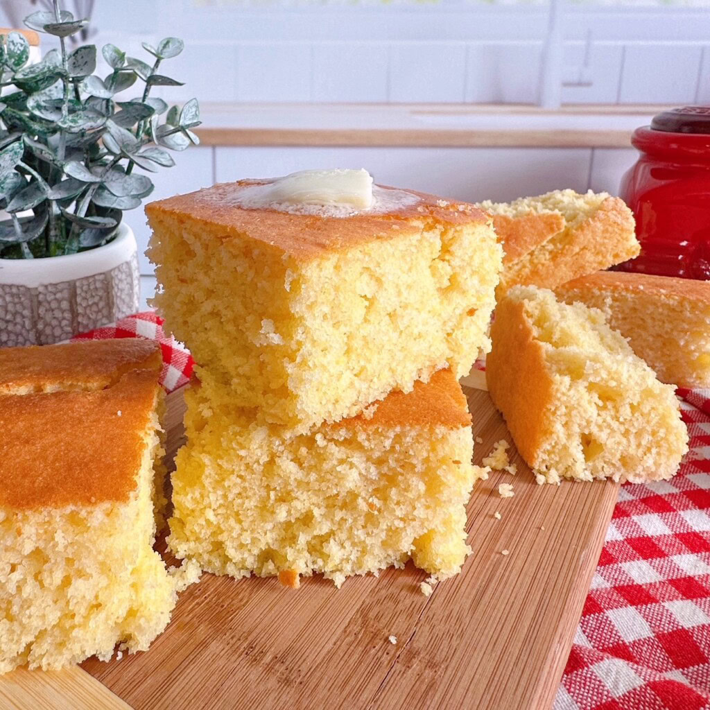 Stacked and cut cornbread with butter.
