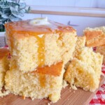Stack of sliced cornbread with honey and melted butter.