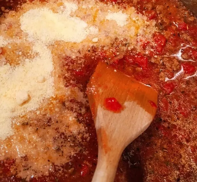 Adding Grated Parmesan Cheese for Italian Beefy Noodle Soup