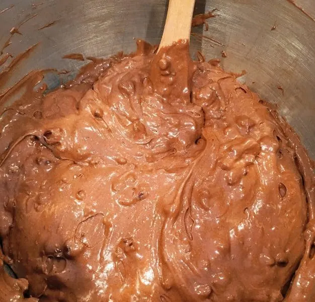 Adding chocolate chips to cake batter.