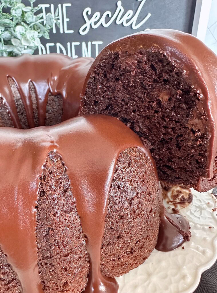 Slice of too much chocolate cake being taken out of the cake for serving.