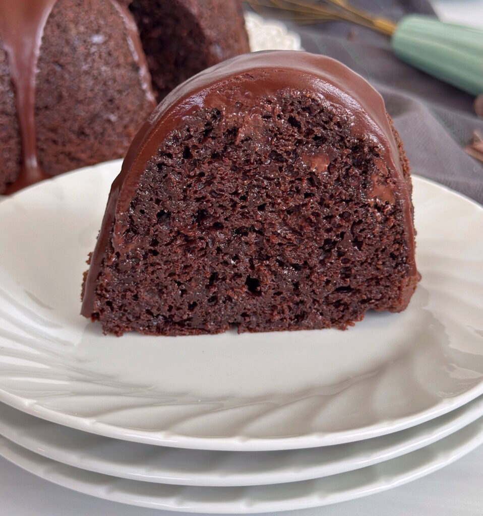 Sliced Chocolate Bundt cake with chocolate satin glaze.