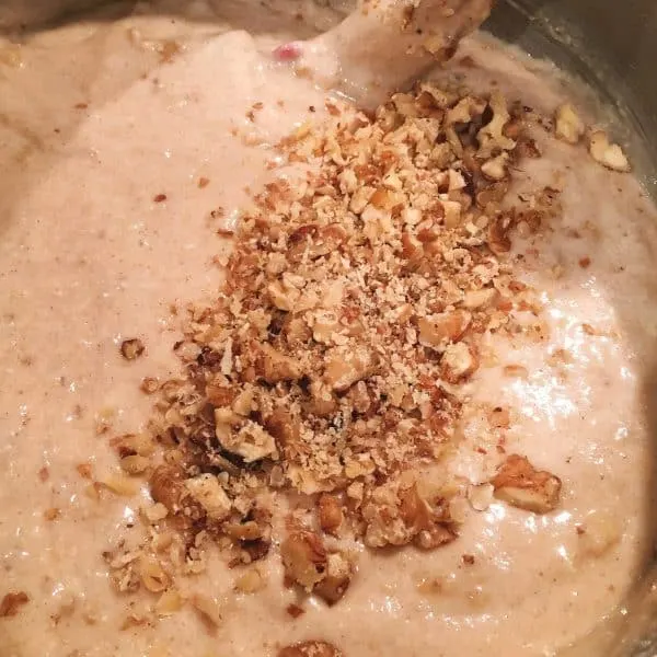 Banana Nut Bread batter in mixing bowl, adding chopped walnuts