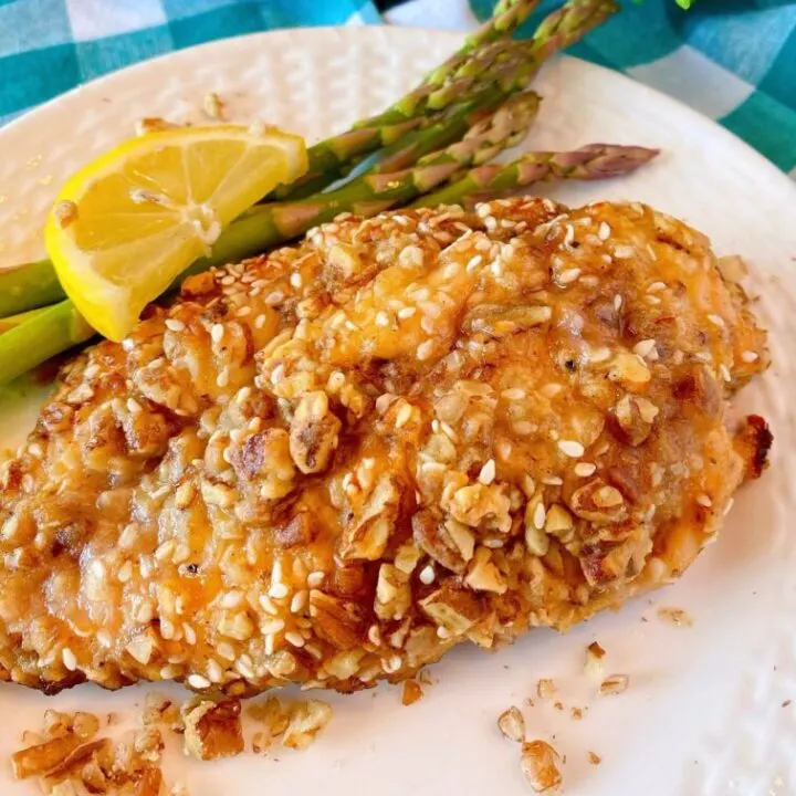 Pecan Chicken on a plate with asparagus