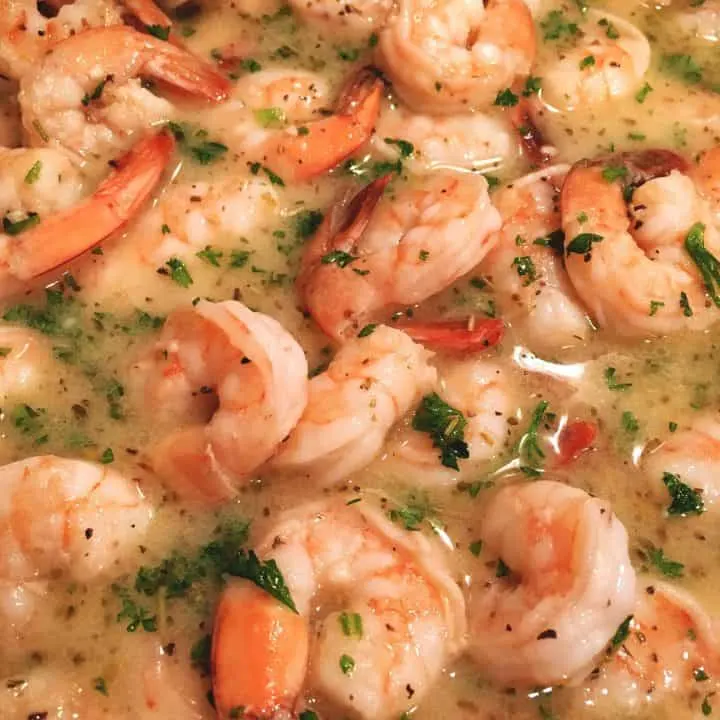 Big juicy tender shrimp in a skillet with a delicious butter wine sauce ready for the lingunie