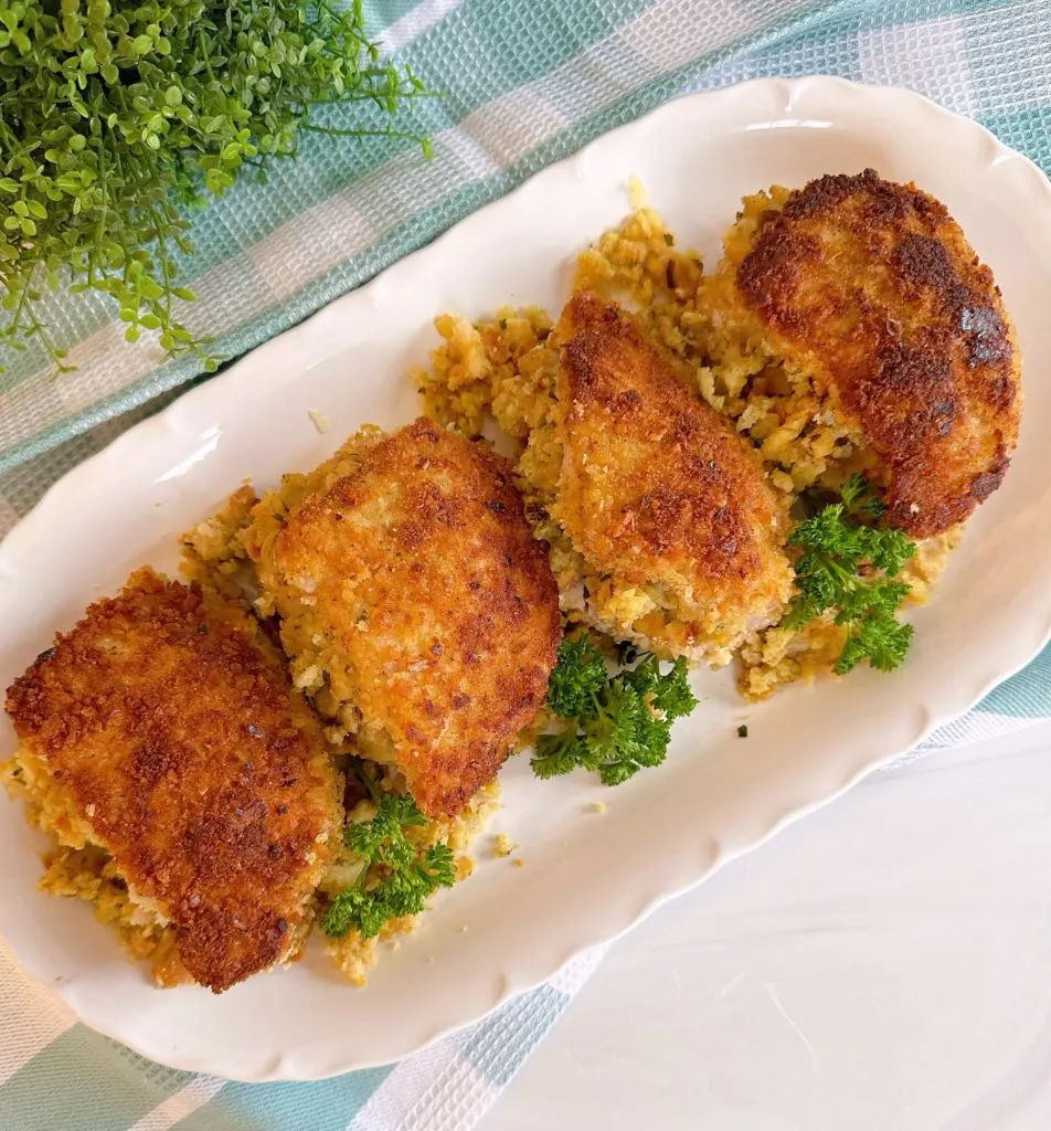 Baked pork chops stuffed on a platter.