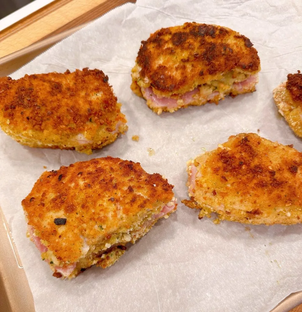 Fried pork chops on baking sheet.