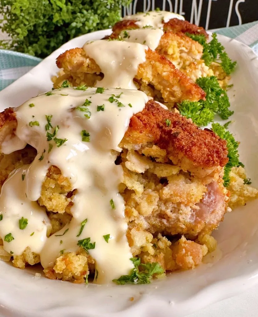 Pork Chops stuffed with stuffing and drizzled with creamy gravy.