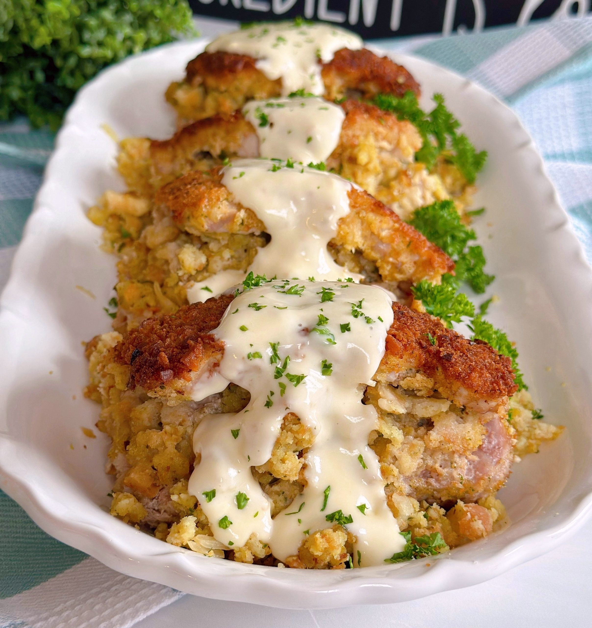 Stuffed Pork Chops on a serving platter with simple gravy.