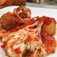 Stuffed pasta shells with cheese and marinara sauce and meat balls