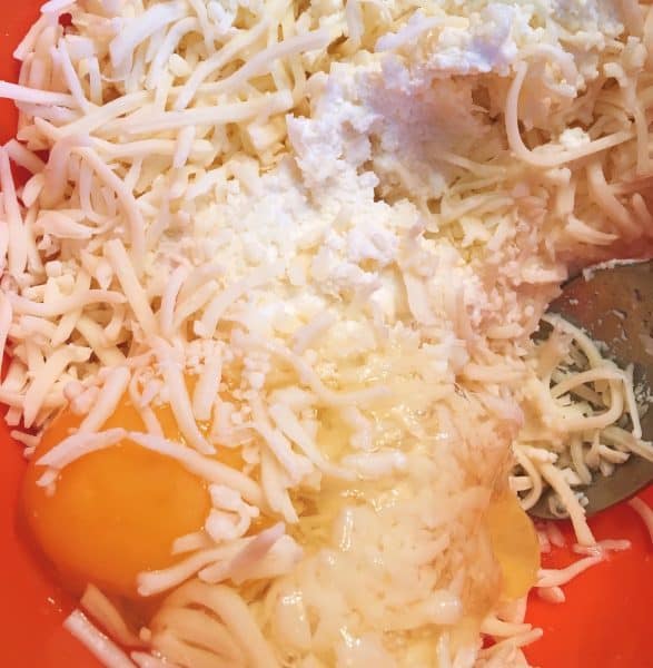 Ricotta Cheese, eggs, and grated cheese in a bowl for shell filling