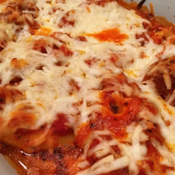 Stuffed shells with sauce and meatballs baked to perfection