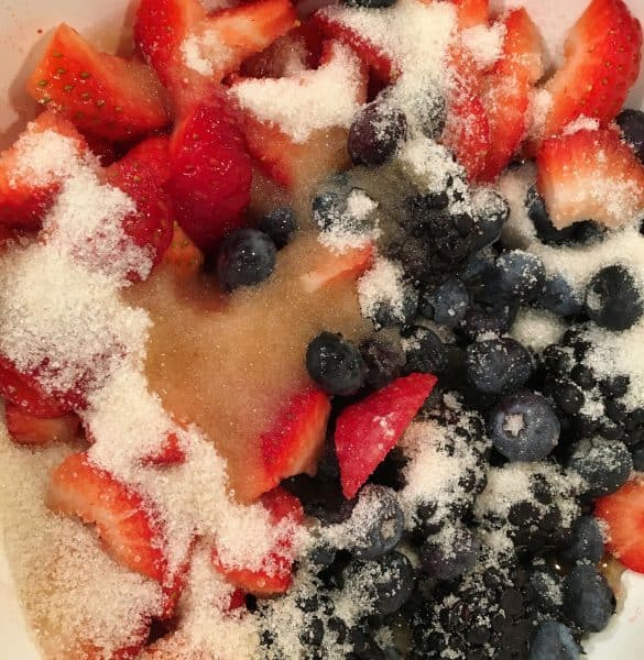Adding sugar to fresh berries for Berry French Toast