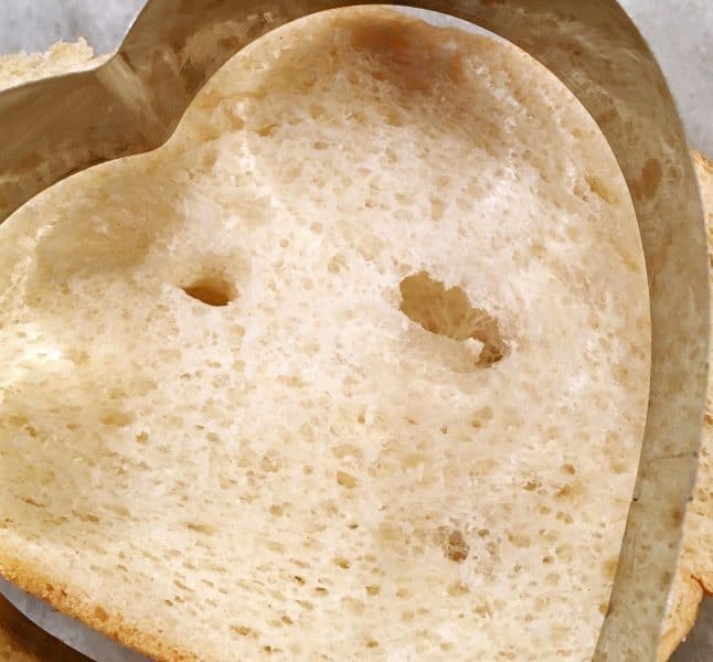 Using a cookie cutter to cut bread for dipping for French Toast