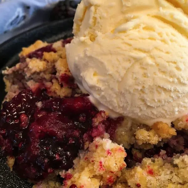 Triple Berry Skillet with Crisp Crumb topped with vanilla ice cream