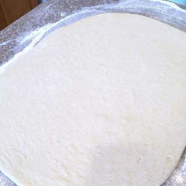 Dough Rolled out into a large rectangle on floured surface.