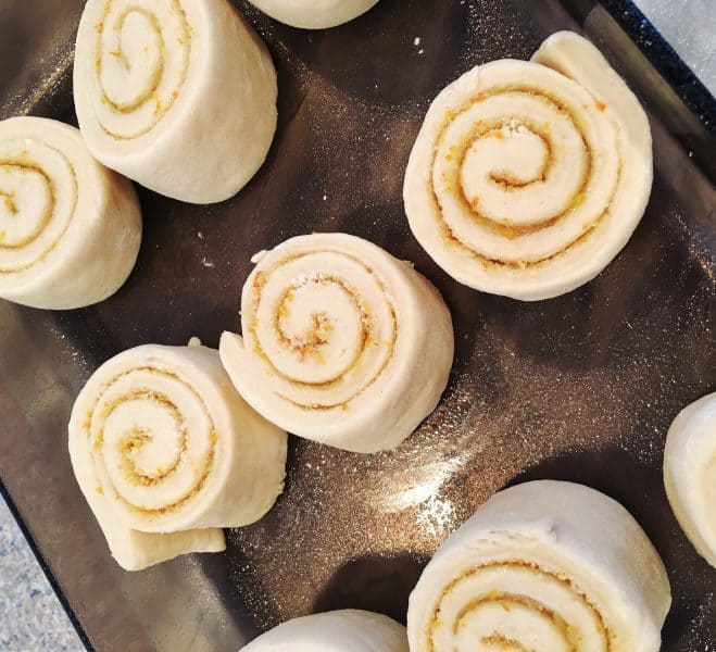 Orange Rolls on baking sheet ready to rise again.