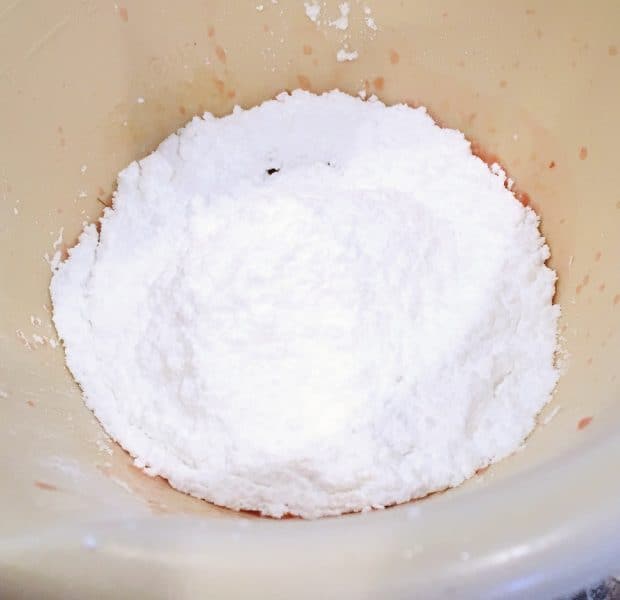 Mixing powder sugar with orange juice