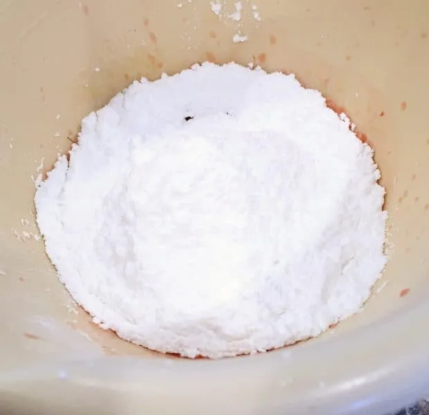 Mixing powder sugar with orange juice