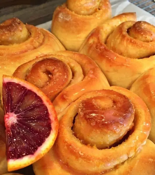 Orange Rolls in a baking dish with Blood Orange Glaze