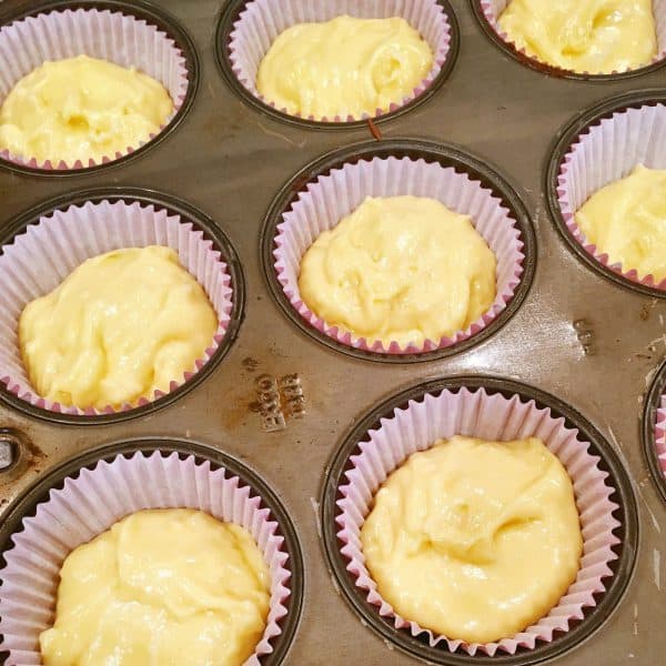 Cupcake pan with liners, and cupcake batter ready to go into the oven