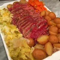 Platter full of corned beef, cabbage, potatoes and carrots