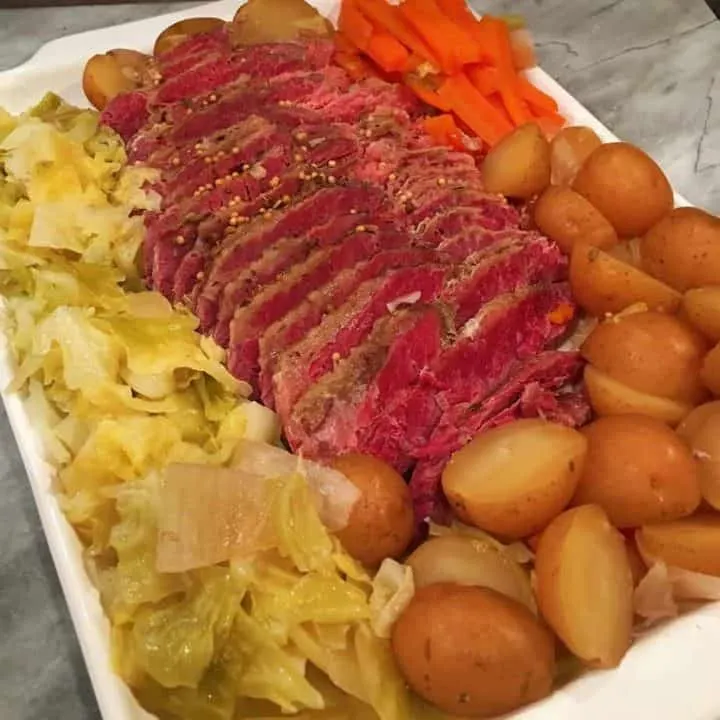 Platter full of corned beef, cabbage, potatoes and carrots