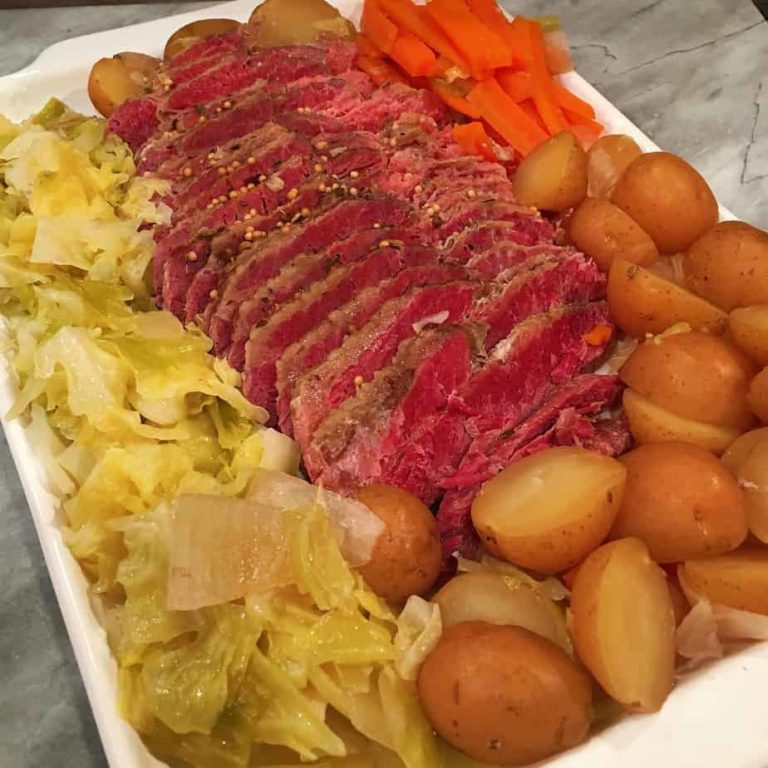 Platter full of corned beef, cabbage, potatoes and carrots.