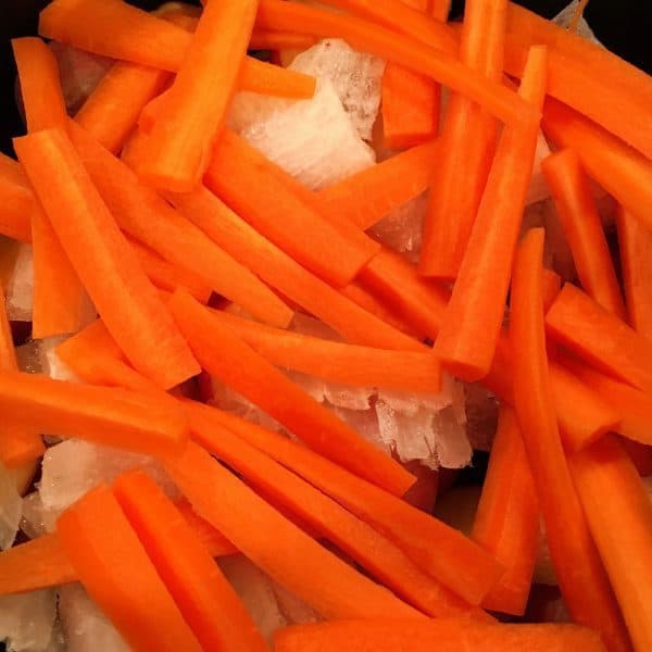 Carrots and onions layered in slow cooker
