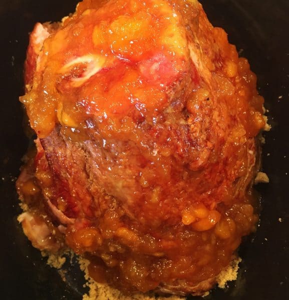 Cover ham with peach glaze in the slow cooker.