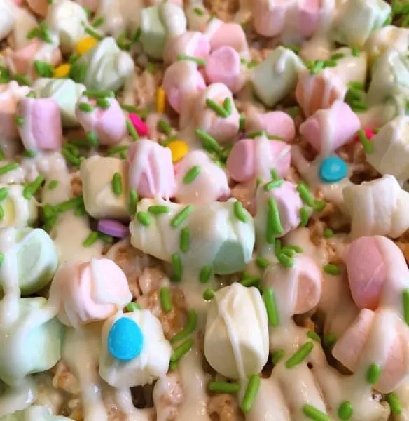 Close up of pastel marshmallows, sprinkles, and chocolate drizzles