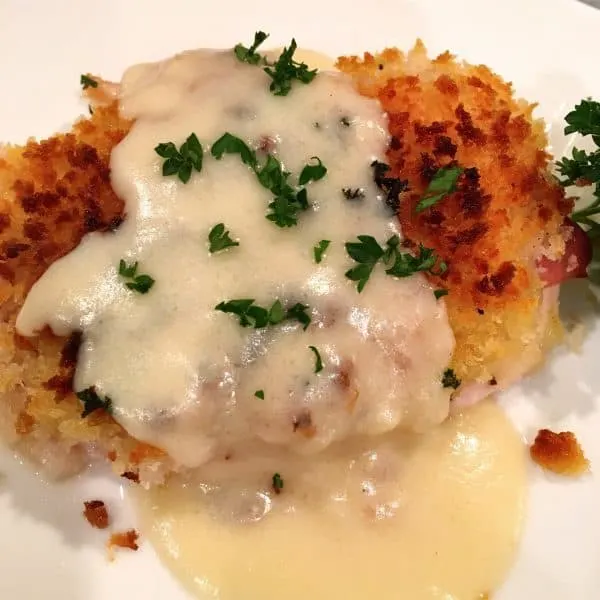 Chicken Cordon Bleu with cheese sauce over the oven baked chicken