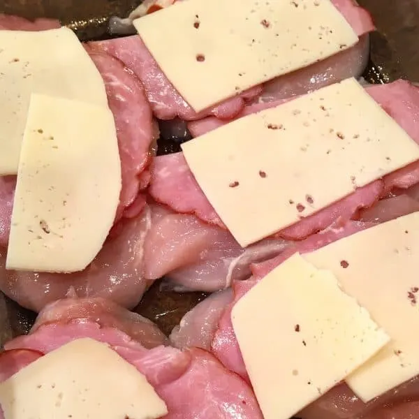 Ham topped with slices of Swiss Cheese