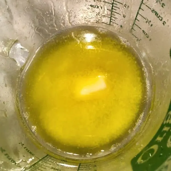 Melted butter in measuring cup