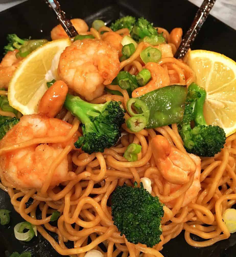 Ginger Lemon Shrimp on a black serving plate with chop sticks.