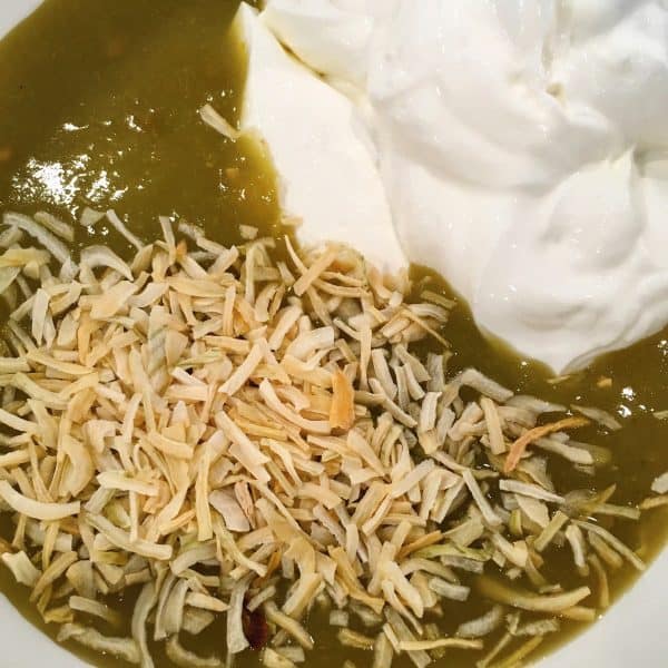 Green enchilada sauce, dried onions, and sour cream for enchiladas