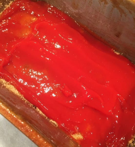 Ketchup on top of brown sugar in loaf pan to create brown sugar glaze