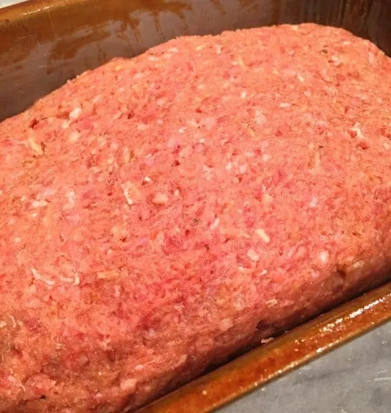 Meat loaf mixture placed on top of ketchup and brown sugar