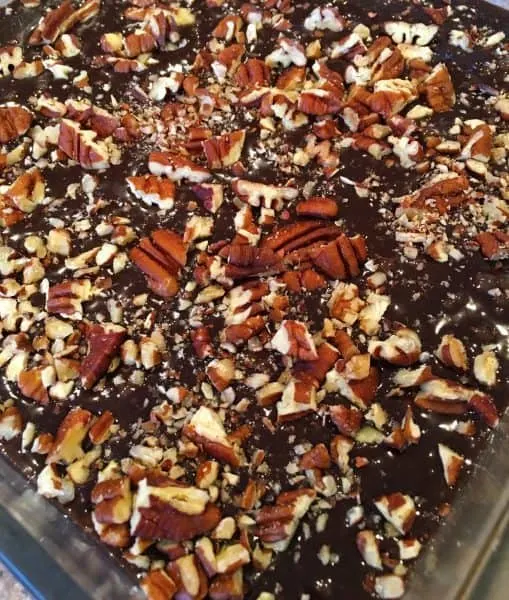 Chopped Pecans added to brownie mix in baking dish