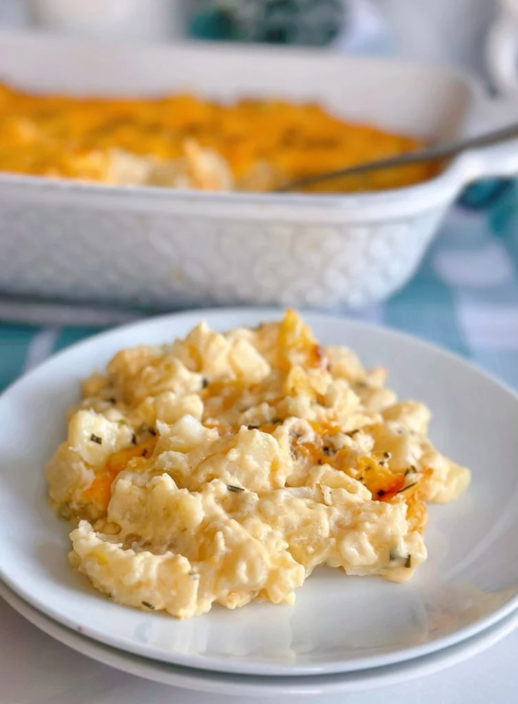 Funeral Cheesy Potatoes with the casserole in the background.